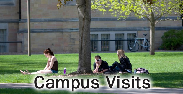 Students sitting by a tree on campus