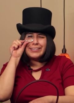 Girl wearing hat with magnified glass